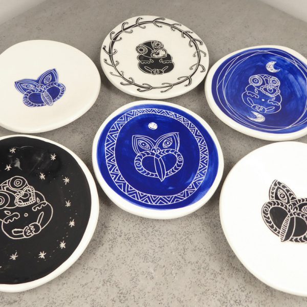 Small ceramic dishes with tiki design, by Borrowed Earth