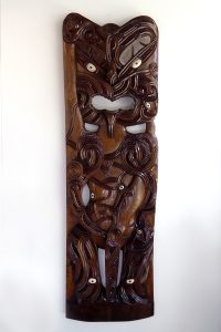 Carved wooden Poupou (part of a maori house) by Hohepa Peni