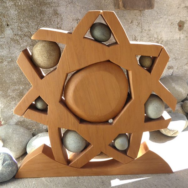 Wood & stone sculpture called 'Wheel of Life' by Peter Radley